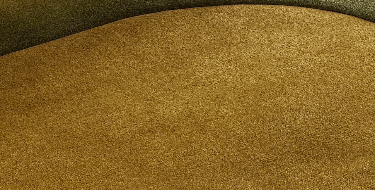 grüner Teppich mit weicher Rundung, Farbverlauf und Relief